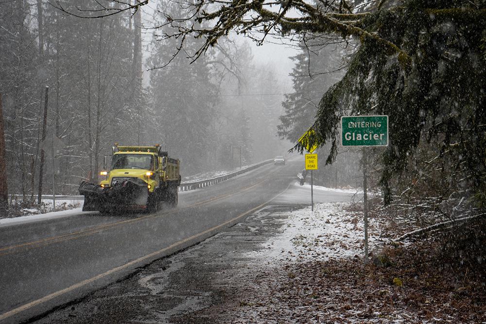 A snowplow ascends Highway 542 towards Mt. Baker, departing Glacier, Wash. amid a snowstorm. Photo by Austin Blacketer.