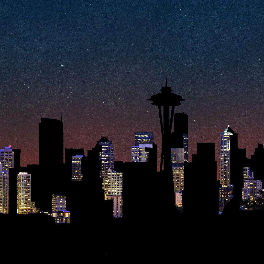 Seattle skyline at night, showing building lights against a darkened sky. 